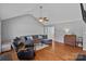 Comfortable living room with hardwood floors, a sectional sofa, and a vintage dresser adding character at 142 Family Ln, Mount Holly, NC 28120