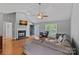 Bright living room with hardwood floors, a fireplace, and a large window offering plenty of natural light at 142 Family Ln, Mount Holly, NC 28120