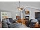 Spacious living room featuring hardwood floors, vaulted ceilings, a cozy fireplace, and modern decor at 142 Family Ln, Mount Holly, NC 28120