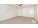 Neutral bedroom featuring neutral carpet, a ceiling fan, and two doors at 1432 Matthew Allen Cir, Kannapolis, NC 28081