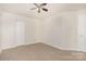 Neutral bedroom showcasing a ceiling fan, closet, and plush carpeting at 1432 Matthew Allen Cir, Kannapolis, NC 28081