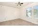 A bedroom with neutral carpet, ceiling fan, and window views at 1432 Matthew Allen Cir, Kannapolis, NC 28081