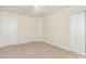 Neutral bedroom featuring neutral carpet, a ceiling fan, and two doors at 1432 Matthew Allen Cir, Kannapolis, NC 28081
