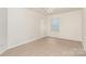 A bedroom with neutral carpet, ceiling fan, and window views at 1432 Matthew Allen Cir, Kannapolis, NC 28081