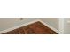 Close-up on wood-look laminate flooring with white trim at 1432 Matthew Allen Cir, Kannapolis, NC 28081