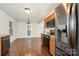 Bright kitchen features black appliances, wooden cabinets, and vinyl flooring overlooking dining area at 1432 Matthew Allen Cir, Kannapolis, NC 28081