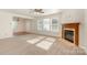 Spacious living room with neutral carpet, fireplace, and natural light streaming through the large windows at 1432 Matthew Allen Cir, Kannapolis, NC 28081