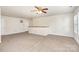 Spacious living room boasting plush neutral carpet, three windows and standard ceiling fan at 1432 Matthew Allen Cir, Kannapolis, NC 28081