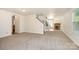 Open-concept living room featuring neutral carpet, fireplace, abundant natural light, and seamless transitions to other areas at 1432 Matthew Allen Cir, Kannapolis, NC 28081