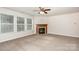 Bright living room featuring neutral carpeting, a fireplace, and an abundance of natural light for a cozy atmosphere at 1432 Matthew Allen Cir, Kannapolis, NC 28081