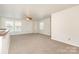 Spacious living room boasting plush neutral carpet, three windows and standard ceiling fan at 1432 Matthew Allen Cir, Kannapolis, NC 28081