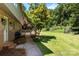The backyard is large, features a wooden deck, and is surrounded by trees at 1505 N Cansler St, Kings Mountain, NC 28086
