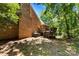 Inviting backyard featuring a wooden deck, brick facade, and lush trees, ideal for outdoor relaxation at 1505 N Cansler St, Kings Mountain, NC 28086