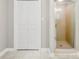 Shower stall next to closet with white bi-fold doors and tile flooring at 1505 N Cansler St, Kings Mountain, NC 28086