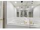 This bathroom has a jacuzzi tub with gold fixtures and mirrored wall at 1505 N Cansler St, Kings Mountain, NC 28086