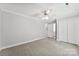 Spacious bedroom with neutral tones and carpet, featuring a ceiling fan and closet at 1505 N Cansler St, Kings Mountain, NC 28086