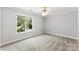 This bedroom has neutral carpet, paint, and a window overlooking trees at 1505 N Cansler St, Kings Mountain, NC 28086