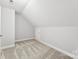 This bedroom features neutral carpet and walls and a ceiling that slopes up at 1505 N Cansler St, Kings Mountain, NC 28086
