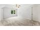 Bright bedroom with a ceiling fan, plush carpet, and natural light from the window at 1505 N Cansler St, Kings Mountain, NC 28086