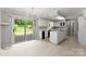 Bright, updated kitchen with white cabinets, an island, and a sliding glass door to the deck at 1505 N Cansler St, Kings Mountain, NC 28086