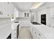 Bright kitchen features white cabinetry, stainless steel appliances, and island with cooktop at 1505 N Cansler St, Kings Mountain, NC 28086