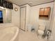 Well-lit bathroom featuring a soaking tub, toilet, cabinet, and built-in shelving at 16711 Indian Mound Rd, Albemarle, NC 28001
