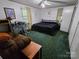 Cozy bedroom with a black bed, accent chair, desk, and a large window providing natural light at 16711 Indian Mound Rd, Albemarle, NC 28001