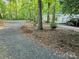 Expansive gravel driveway leading to the home with surrounding trees for added privacy at 16711 Indian Mound Rd, Albemarle, NC 28001