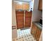 View of the kitchen from a doorway, including wooden cabinets and saloon doors to another room at 16711 Indian Mound Rd, Albemarle, NC 28001