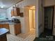 Open concept kitchen leading to hallway with light cabinets and modern appliances offering seamless flow and functionality at 16711 Indian Mound Rd, Albemarle, NC 28001