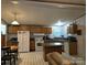 Open concept kitchen featuring light wooden cabinets, a kitchen island and modern appliances at 16711 Indian Mound Rd, Albemarle, NC 28001