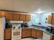 Spacious kitchen with light wooden cabinets, modern appliances, and a double sink, creating a welcoming atmosphere at 16711 Indian Mound Rd, Albemarle, NC 28001