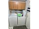 Functional laundry room with washer, dryer, cabinets, and storage space, offering convenience and organization at 16711 Indian Mound Rd, Albemarle, NC 28001