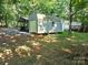 Exterior view featuring a large utility shed adjacent to the house and carport at 16711 Indian Mound Rd, Albemarle, NC 28001