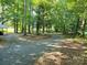 Spacious and secluded gravel yard surrounded by mature trees with plenty of space for parking at 16711 Indian Mound Rd, Albemarle, NC 28001