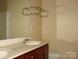 Bathroom with double sinks, white counter and vanity with wooden cabinets, wall mirror and a towel rack at 1814 Birch Heights Ct, Charlotte, NC 28213