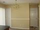 Dining room with chandelier, beige walls, and doors leading to other rooms of the house at 1814 Birch Heights Ct, Charlotte, NC 28213