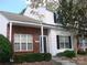 Charming brick and white two-story townhouse with a well-maintained front yard and welcoming entrance at 1814 Birch Heights Ct, Charlotte, NC 28213