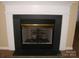 Living room fireplace with a white mantel, black firebox and a metal mesh screen at 1814 Birch Heights Ct, Charlotte, NC 28213