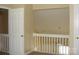 Hallway with white wooden railing overlooking the lower level of the home at 1814 Birch Heights Ct, Charlotte, NC 28213