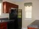 Kitchen area with black appliances, sink, dark countertops, and a window bringing in light at 1814 Birch Heights Ct, Charlotte, NC 28213
