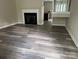 Spacious living room with hardwood flooring and a cozy fireplace, creating an inviting atmosphere at 1814 Birch Heights Ct, Charlotte, NC 28213