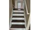 Classic staircase with hardwood steps and white railing, blending style and functionality at 1814 Birch Heights Ct, Charlotte, NC 28213