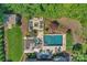 Aerial view showcasing the pool, patio area, fire pit, and lush landscaping of the backyard at 2009 Freeport Dr, Indian Trail, NC 28079