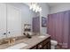 This half bath has a double sink vanity with granite counters and a framed mirror at 2009 Freeport Dr, Indian Trail, NC 28079