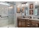 The bathroom features a double sink vanity with granite counters and a stunning walk-in shower at 2009 Freeport Dr, Indian Trail, NC 28079