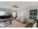 Bright bedroom with dual workstation setup, cozy seating, and a Super Bowl Champions banner at 2009 Freeport Dr, Indian Trail, NC 28079