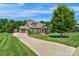 Beautiful home with three-car garage, stone accents, and a long driveway surrounded by lush greenery at 2009 Freeport Dr, Indian Trail, NC 28079