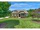 Charming home with stone accents, lush green lawn, and mature trees, offering a serene setting at 2009 Freeport Dr, Indian Trail, NC 28079