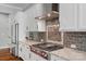 Close-up of the kitchen features including a stainless steel hood and tile backsplash at 2009 Freeport Dr, Indian Trail, NC 28079